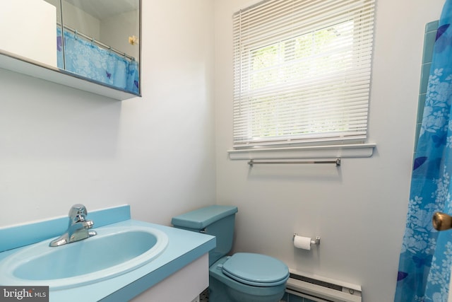 full bathroom featuring vanity, curtained shower, baseboard heating, and toilet