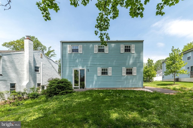 back of property with a yard