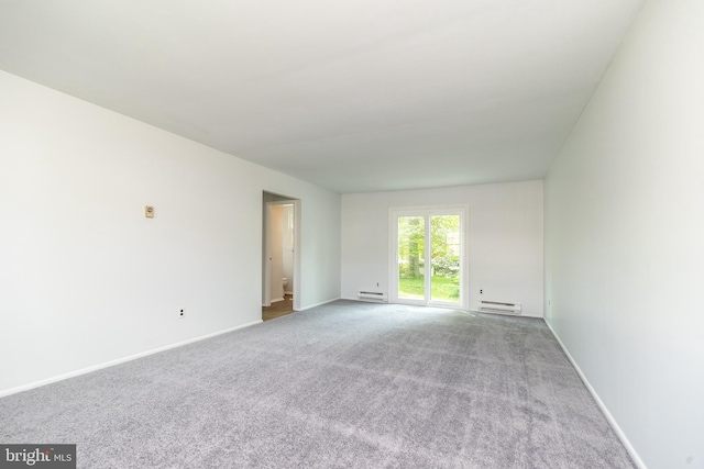 carpeted empty room with baseboards and a baseboard heating unit