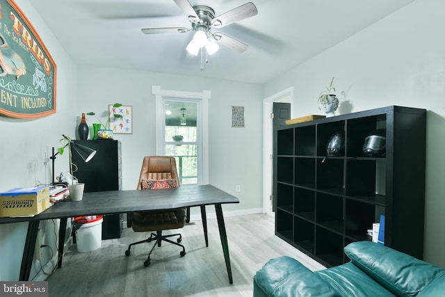 office space featuring wood finished floors, a ceiling fan, and baseboards