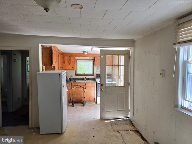 32939 Old Ocean City Rd, Parsonsburg, MD 21849 - kitchen with a sink, range with electric cooktop, brown cabinetry, and white fridge