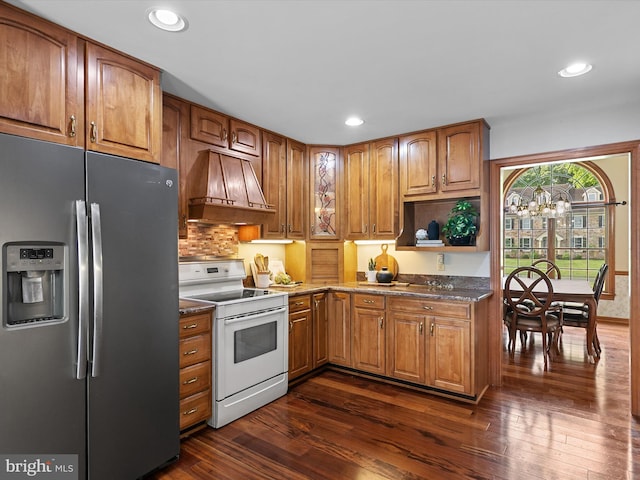 12553 Fawn Dr, Laurel, DE 19956 - kitchen with stainless steel fridge, white electric range oven, premium range hood, dark wood finished floors, and brown cabinetry