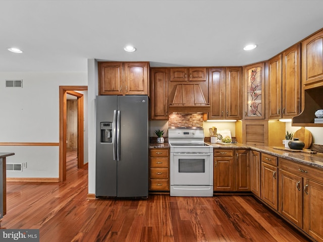 12553 Fawn Dr, Laurel, DE 19956 - kitchen featuring stainless steel refrigerator with ice dispenser, white electric range, premium range hood, brown cabinetry, and recessed lighting