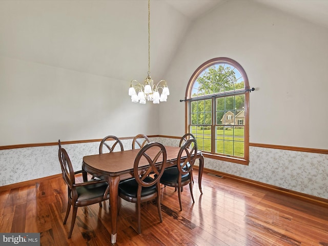 12553 Fawn Dr, Laurel, DE 19956 - dining area with wallpapered walls, lofted ceiling, baseboards, wood finished floors, and a chandelier