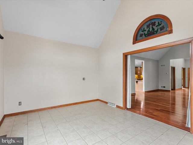 12553 Fawn Dr, Laurel, DE 19956 - spare room with vaulted ceiling, light tile patterned flooring, and baseboards