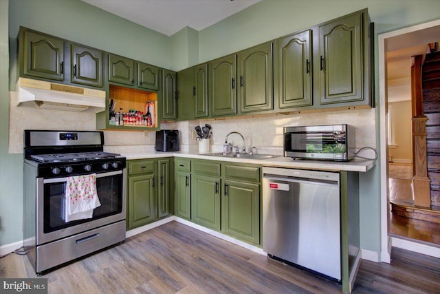 4324 Cresson St, Philadelphia, PA 19127 - kitchen featuring under cabinet range hood, stainless steel appliances, a sink, and green cabinets