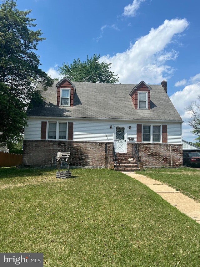 321 W Center Ave, Maple Shade, NJ 08052 - cape cod house with brick siding, a front yard, and a chimney