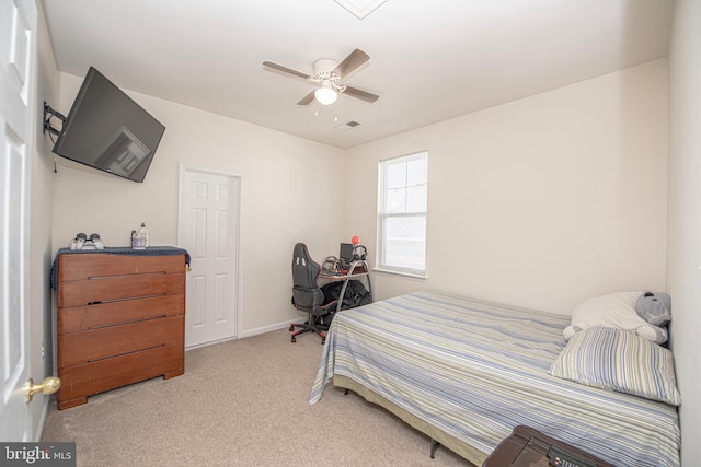 carpeted bedroom featuring visible vents, a ceiling fan, and baseboards
