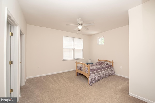 bedroom with baseboards, ceiling fan, light carpet, and visible vents