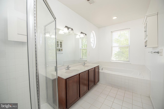 full bath featuring tile patterned flooring, a sink, a bath, and a stall shower