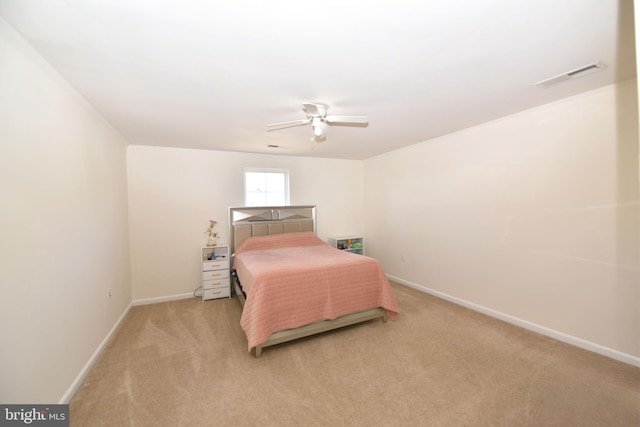 bedroom with a ceiling fan, baseboards, light colored carpet, and visible vents