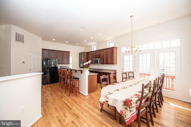 dining space featuring visible vents, an inviting chandelier, light wood-style floors, baseboards, and recessed lighting