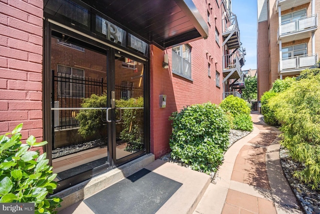 view of exterior entry with brick siding