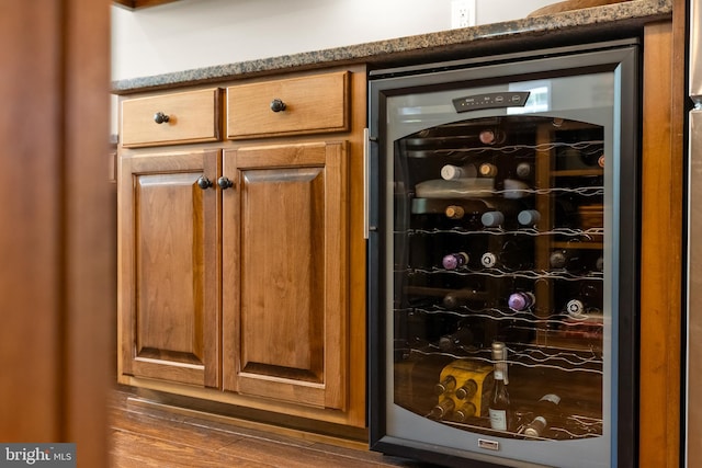 bar with wine cooler and wood finished floors
