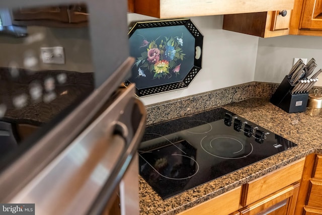 details featuring brown cabinetry and black electric cooktop