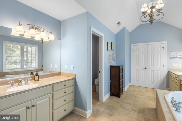 full bath featuring visible vents, vanity, an inviting chandelier, toilet, and a bath