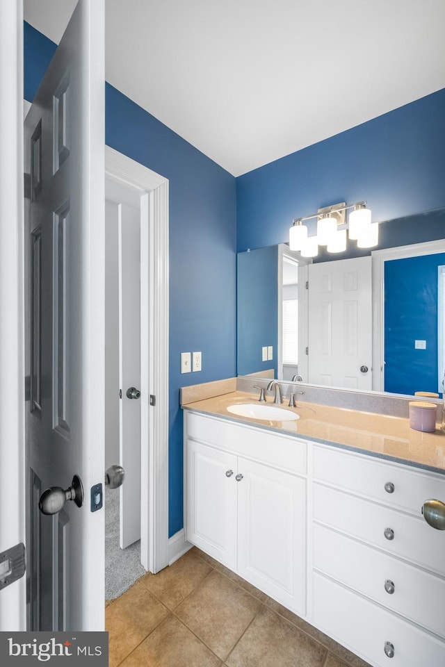 bathroom featuring vanity, baseboards, and tile patterned floors