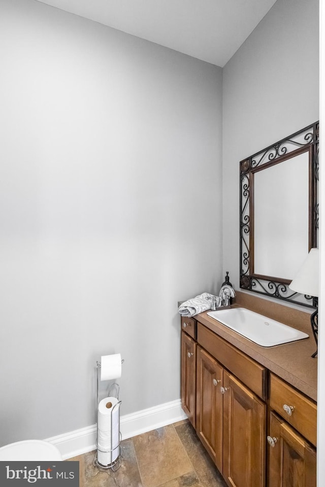bathroom with baseboards and vanity