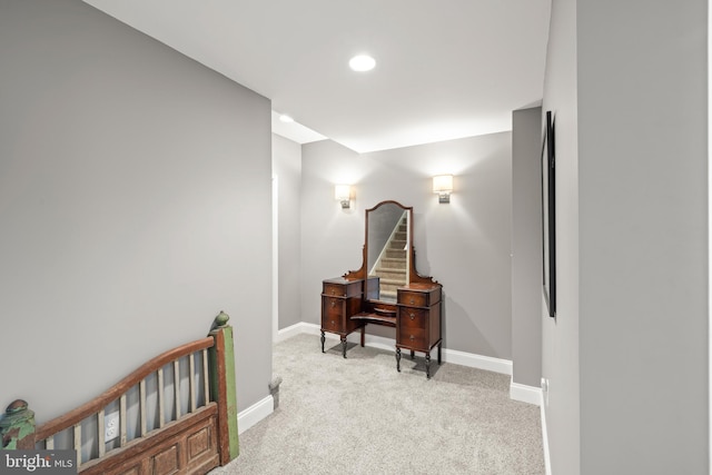 hall with baseboards, recessed lighting, and light colored carpet