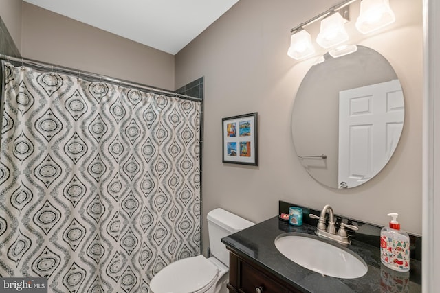 full bathroom with toilet, curtained shower, and vanity