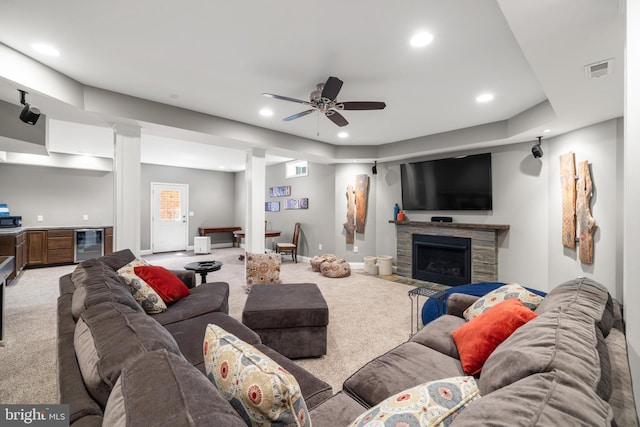 living area with visible vents, recessed lighting, beverage cooler, and light colored carpet