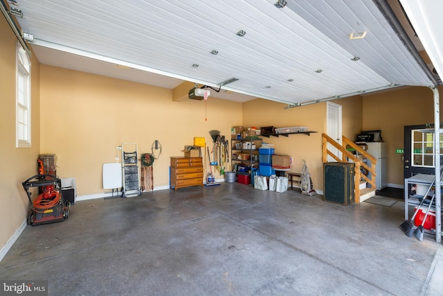garage with baseboards and a garage door opener