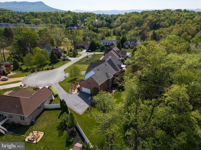 aerial view with a forest view, a residential view, and a mountain view