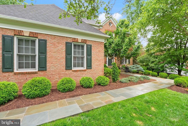 12019 Wandabury Rd, Oakton, VA 22124 - view of property exterior featuring roof with shingles, brick siding, and a lawn