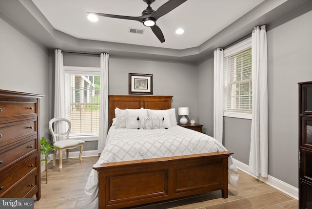 12019 Wandabury Rd, Oakton, VA 22124 - bedroom with multiple windows, baseboards, and light wood-style floors