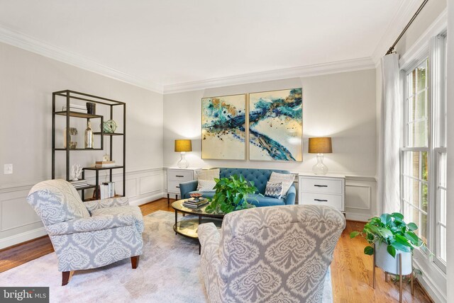 12019 Wandabury Rd, Oakton, VA 22124 - living area with light wood-type flooring, healthy amount of natural light, crown molding, a decorative wall, and wainscoting