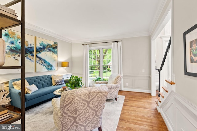 12019 Wandabury Rd, Oakton, VA 22124 - living area with stairway, ornamental molding, light wood-style floors, a decorative wall, and wainscoting