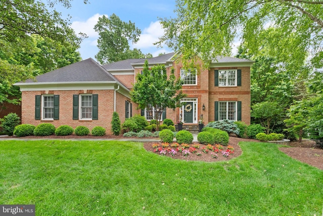 12019 Wandabury Rd, Oakton, VA 22124 - view of front of property with brick siding, a front lawn, and a shingled roof