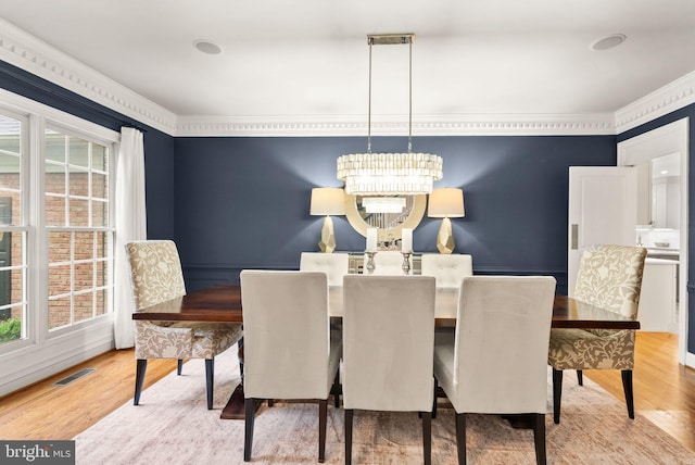 12019 Wandabury Rd, Oakton, VA 22124 - dining space featuring plenty of natural light, a chandelier, wood finished floors, and crown molding