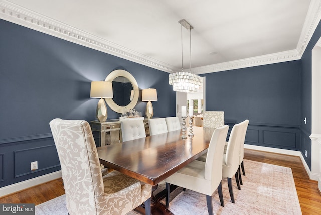 12019 Wandabury Rd, Oakton, VA 22124 - dining space featuring a decorative wall, a chandelier, ornamental molding, wood finished floors, and a wainscoted wall