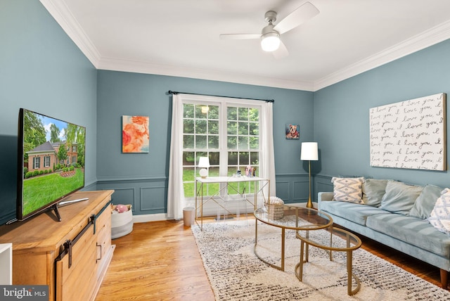 12019 Wandabury Rd, Oakton, VA 22124 - living area featuring ornamental molding, light wood-style floors, a ceiling fan, a decorative wall, and wainscoting
