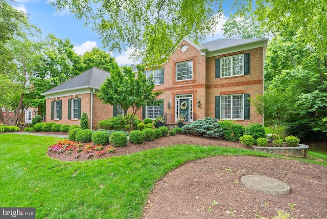 12019 Wandabury Rd, Oakton, VA 22124 - view of front of home with brick siding, a front yard, and a shingled roof