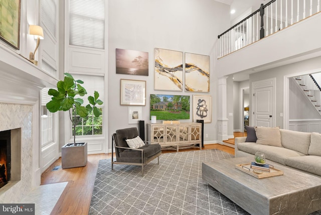 12019 Wandabury Rd, Oakton, VA 22124 - living area with wood finished floors, a high ceiling, stairs, a premium fireplace, and baseboards