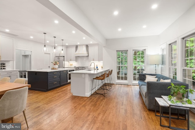 12019 Wandabury Rd, Oakton, VA 22124 - kitchen with premium range hood, a kitchen breakfast bar, light countertops, a sink, and backsplash