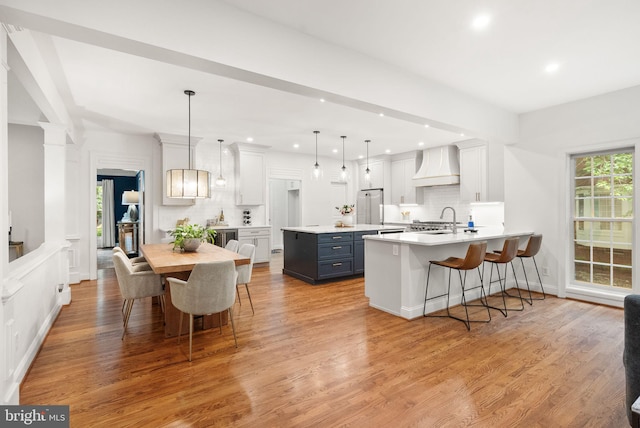 12019 Wandabury Rd, Oakton, VA 22124 - kitchen featuring premium range hood, backsplash, light countertops, light wood-type flooring, and recessed lighting