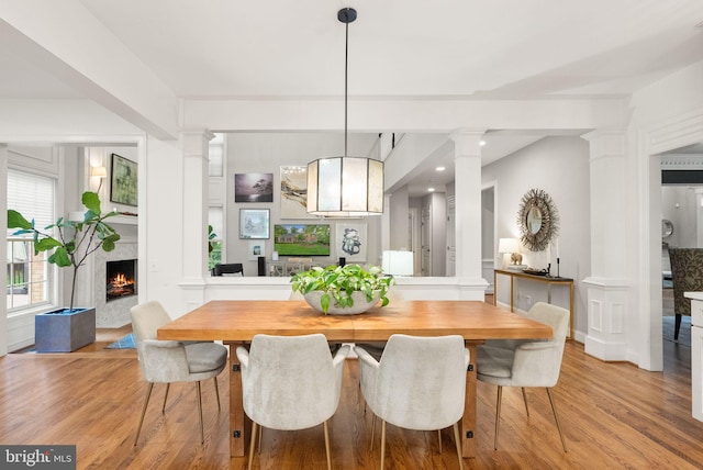 12019 Wandabury Rd, Oakton, VA 22124 - dining space with ornate columns, light wood-style flooring, a fireplace, and recessed lighting