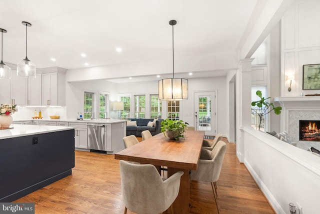 12019 Wandabury Rd, Oakton, VA 22124 - dining room featuring light wood-style flooring, recessed lighting, and a premium fireplace