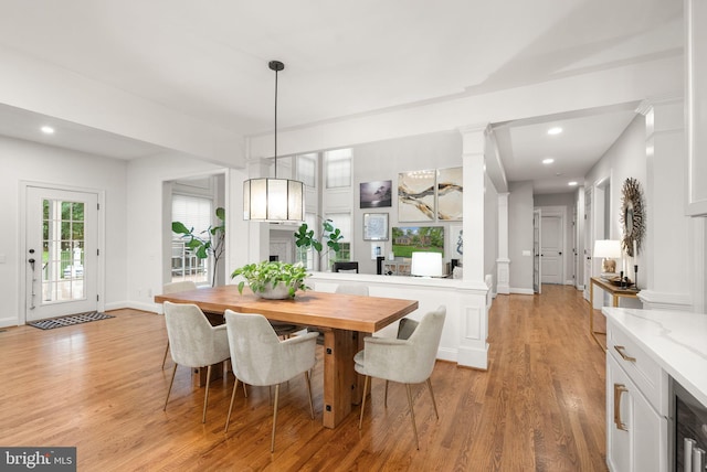 12019 Wandabury Rd, Oakton, VA 22124 - dining space with light wood-style floors, ornate columns, recessed lighting, baseboards, and beverage cooler