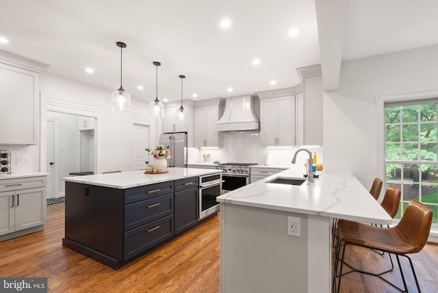 12019 Wandabury Rd, Oakton, VA 22124 - kitchen with custom range hood, a sink, high quality appliances, tasteful backsplash, and a peninsula