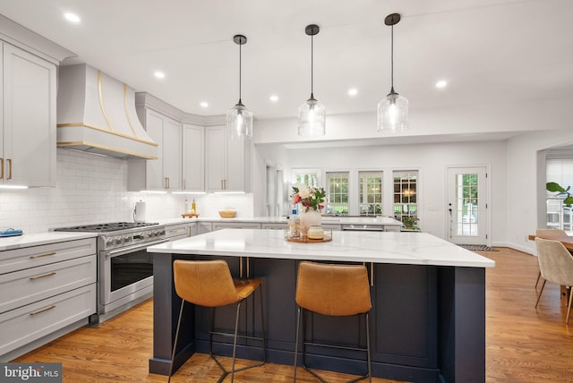 12019 Wandabury Rd, Oakton, VA 22124 - kitchen featuring premium range hood, high end stove, a kitchen island, decorative backsplash, and recessed lighting