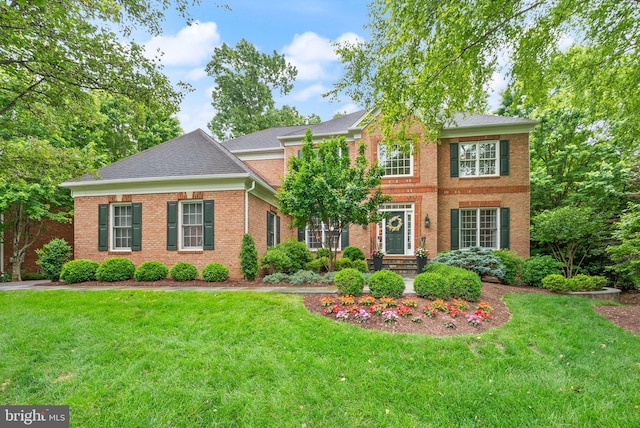 12019 Wandabury Rd, Oakton, VA 22124 - view of front of property featuring brick siding, a front yard, and a shingled roof