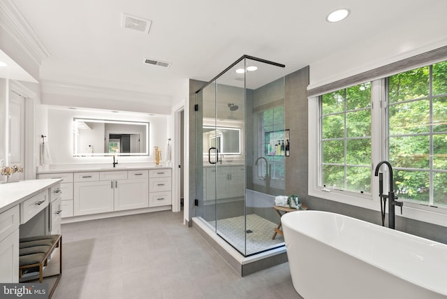 12019 Wandabury Rd, Oakton, VA 22124 - bathroom with vanity, a shower stall, a freestanding tub, and recessed lighting