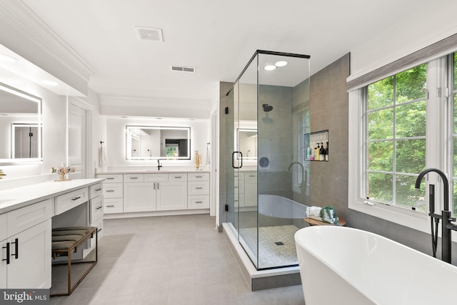 12019 Wandabury Rd, Oakton, VA 22124 - bathroom with two vanities, a shower stall, plenty of natural light, and a soaking tub