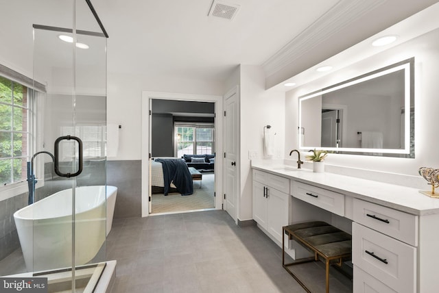 12019 Wandabury Rd, Oakton, VA 22124 - ensuite bathroom with vanity, a soaking tub, ornamental molding, recessed lighting, and a shower stall