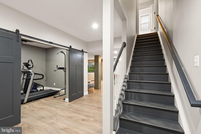 12019 Wandabury Rd, Oakton, VA 22124 - staircase with a barn door, wood finished floors, and baseboards