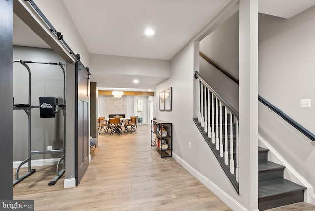 12019 Wandabury Rd, Oakton, VA 22124 - entryway with a barn door, recessed lighting, light wood-type flooring, baseboards, and stairs